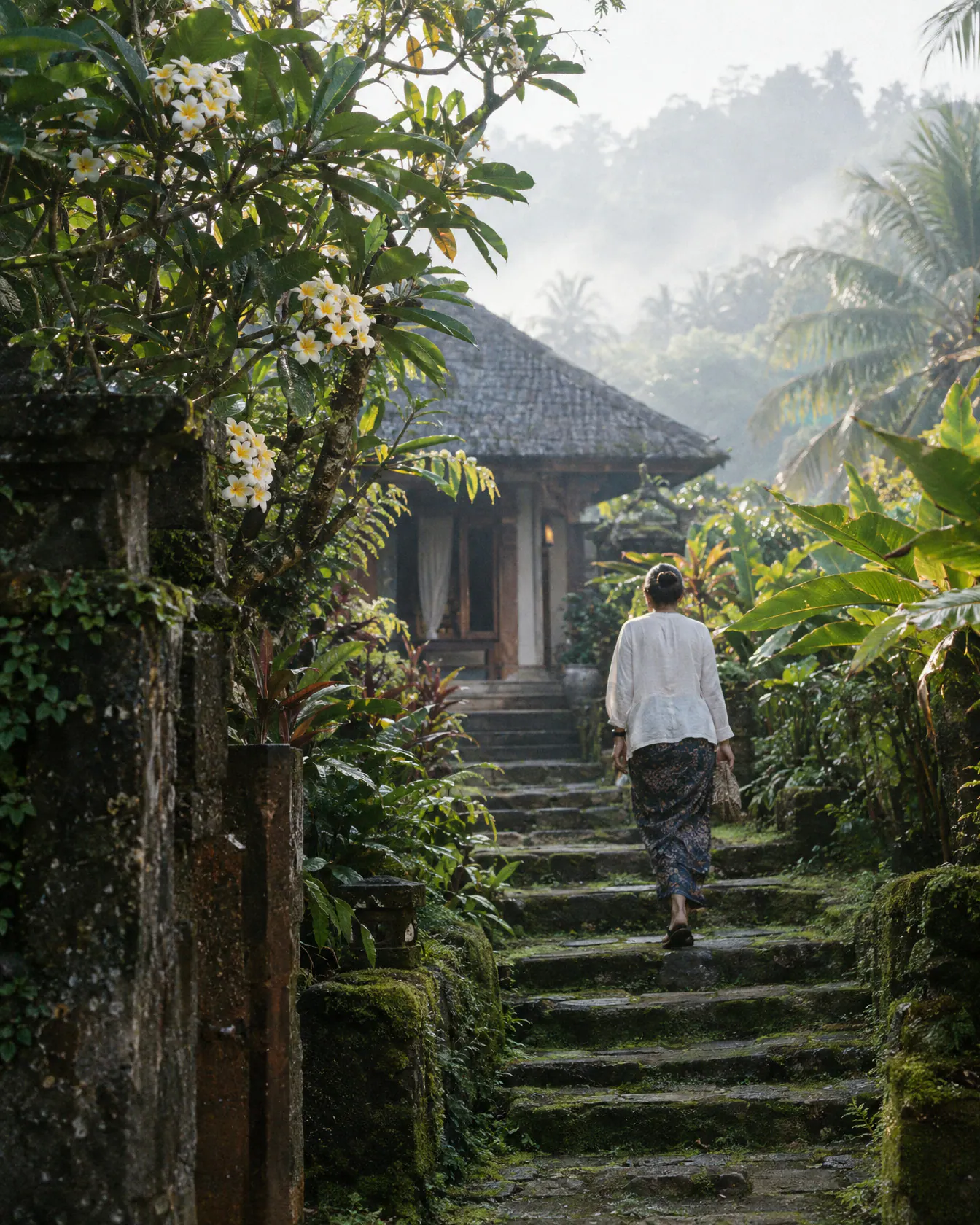 A mossy stone path through jungle to a small villa in Ubud, Bali